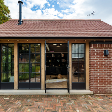 Contemporary outdoor living space looks incredible with new steel windows and doors